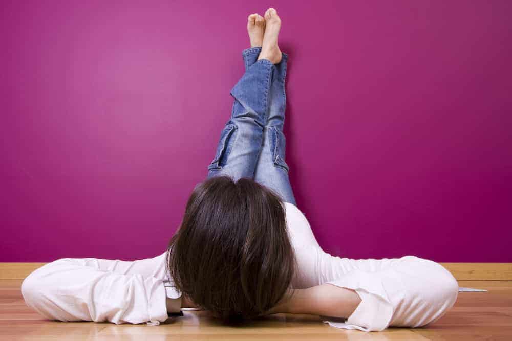 Personal year - relaxed woman with feet to the wall
